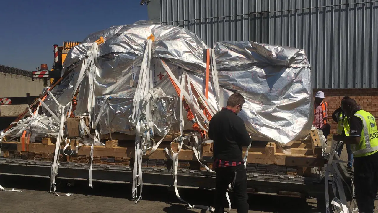 Wrapped machine modules arriving for installation